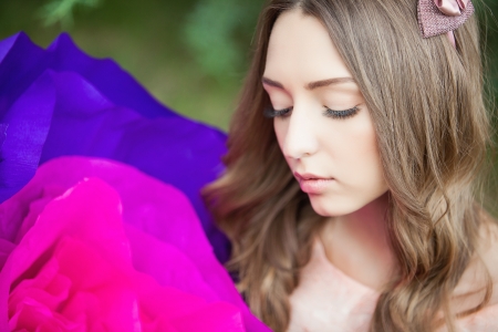 Fancy Daydreaming Woman with a huge flower in hands. Surrealismの写真素材