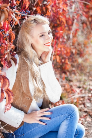 Beautiful elegant woman in autumn parkの写真素材