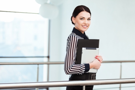 Young smiling business woman holding digital tablet computerの写真素材