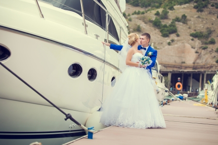 Beautiful bride and groom wedding couple near sea yachtの写真素材