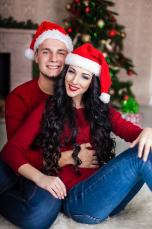 Christmas Couple.Happy Smiling Family at home celebrating. New yearの写真素材