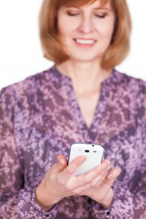 Happy mature lady talking on mobile phone. Isolated on white background.の写真素材