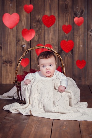 Sweet little baby girl crawling on a wooden floorの写真素材
