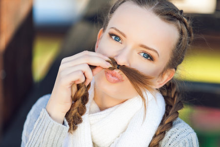 Portrait of lovely young female sitting on steps and smilingの写真素材