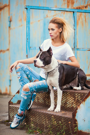 modern punk fashion, portrait of a beautiful model posing on the street with dog. Modern Youth Lifestyle Conceptの写真素材