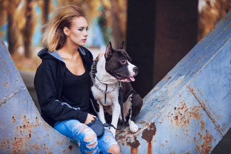 modern punk fashion, portrait of a beautiful model posing on the street with dog. Modern Youth Lifestyle Conceptの写真素材
