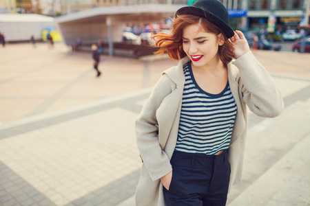 young stylish pretty woman with hat posing in the city streets. vacation europeの写真素材
