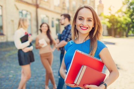 Shot of college students hanging out on campus. Happy classmatesの写真素材