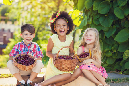 A happy group of Multi-ethnic children sitting happilyの写真素材