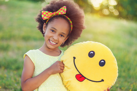 Outdoor portrait of pretty mixed race African-American girl smiling outdoorの写真素材