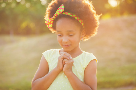 Outdoor portrait of pretty mixed race African-American girl smiling outdoorの写真素材
