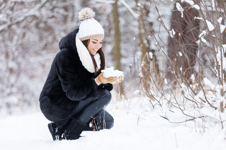 Winter woman in snow outside in nature. Portrait closeup outdoors in snowの写真素材