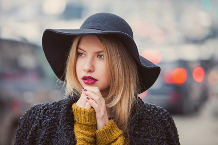 Fashionable young woman posing outside in a city street. Winter Fashionの写真素材