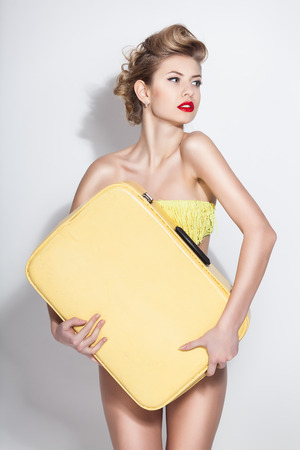 beautiful woman with vintage suitcaseの写真素材