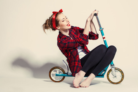 Pretty young woman with scooterの写真素材
