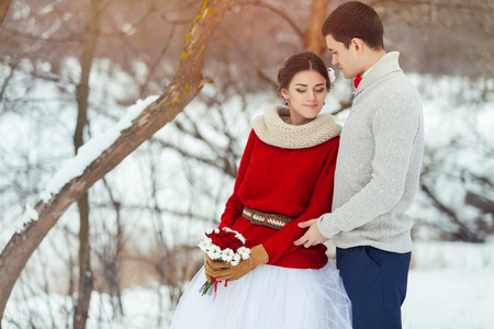 Bride and groom in winter forestの写真素材