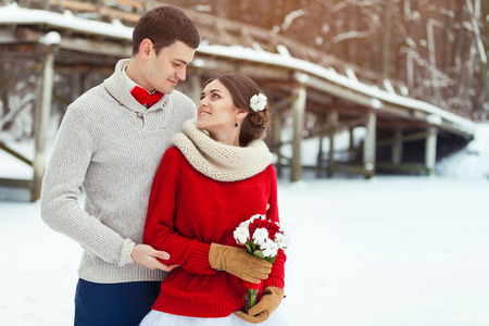 Bride and groom in winter forestの写真素材