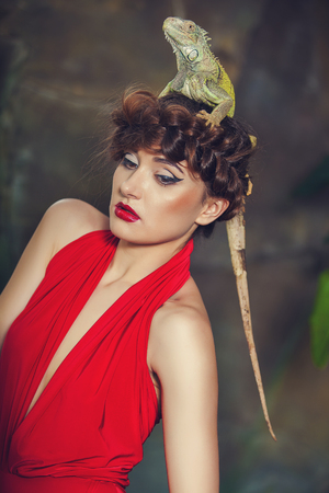 Portrait of young woman with iguanaの写真素材