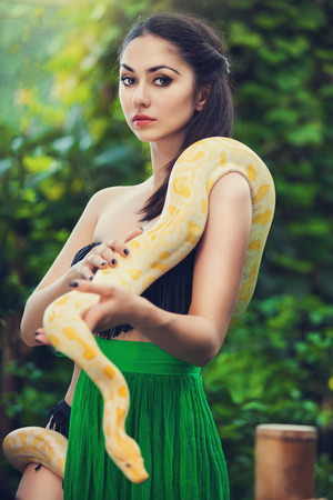sexy woman holding pythonの写真素材