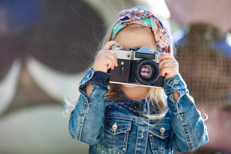 Beautiful smiling girl holding cameraの写真素材