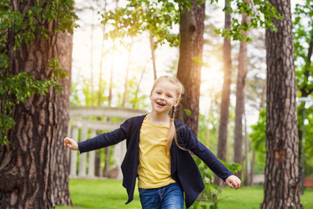 Happy kid girl having fun in the parkの写真素材
