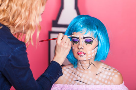 Professional make-up artist makes comic pop art make up. Creative beauty style