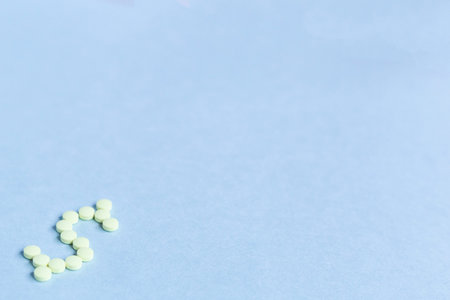 tablets in the form of a dollar sign on a blue background. Concept of a dollar sign made with...