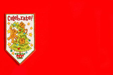 Christmas background with embroidered new year flag on red background, holiday, new year and...