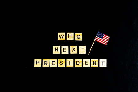 The phrase Who is the next American President - with an American flag in the background. A new election race in the United States. Primary. Candidates. Politics. Government. Force. flatlay, top viewの写真素材