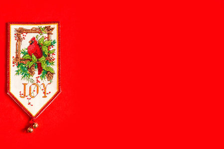Christmas background with embroidered new year flag on red background, holiday, new year and...