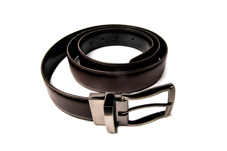 stylish mens brown leather belt with nickel buckle on a white backgroundの写真素材