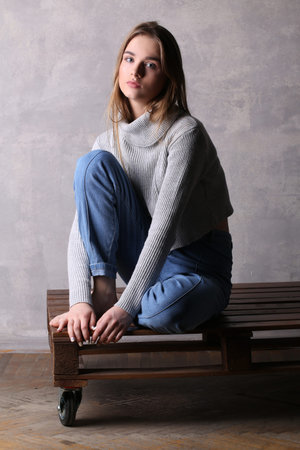 Sitting girl posing on a deck, girl with crossed legs, high fashion look, sitting girl, beautiful...