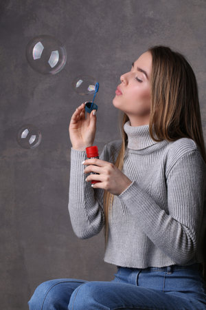 Blonde blowing bubbles, bubble blower , high fashion look, beautiful girl, blonde girl, isolated,...