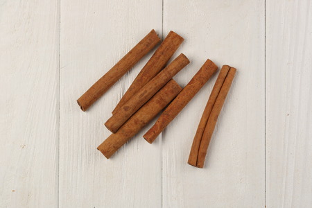 Cinnamon on the table, ingredients and preparation, health benefits of cinnamon, food for restaurant, close up, white backgroundの写真素材