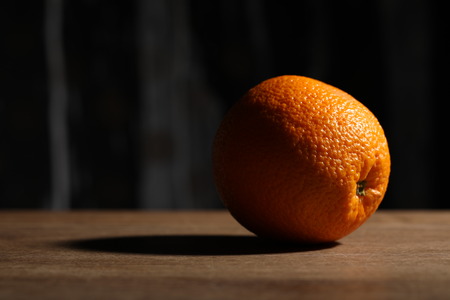 Orange on the wooden table. Close upの写真素材