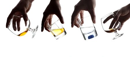 Male hand holding a glass of whiskey with ice cubes.の写真素材