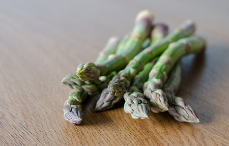 Close-up of fresh green asparagus on wooden background. angle view.の写真素材