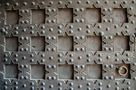 Gate in Castle of the Teutonic Order in Malbork, Poland. Wooden ancient door with geometric ornament and metallic ring.のeditorial素材
