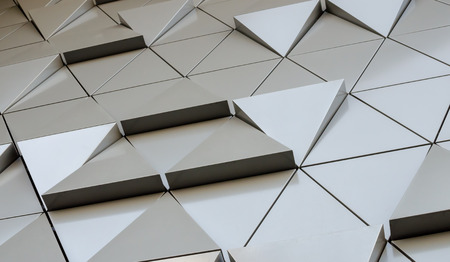 Futuristic Wall of relief metallic triangles. 3d geometric background. low angle viewの写真素材