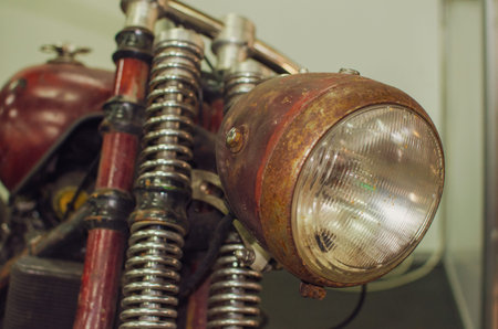 WROCLAW, POLAND - August 11, 2019: USA cars show: Close up shot of a vintage motorcycle headlight.のeditorial素材