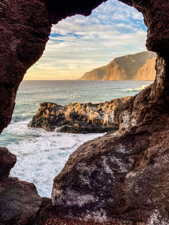 view through the hole in the stones of the coast in Los Gigantos area, Tenerife, Canary Islandsの写真素材