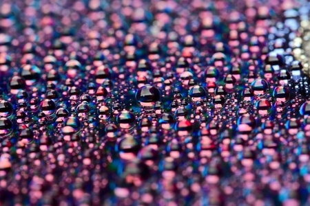 water drops on dark disk surfaceの写真素材