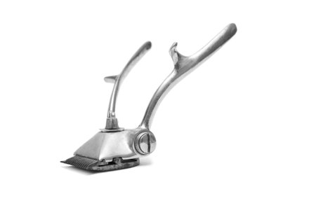 Old metal hair trimmer isolated on white