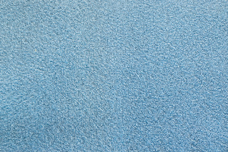 Rough light turquoise blue color blanket detail texture background made from plush furry fleece...