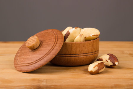 Nuts in a wooden bowl on a wooden background. Healthy Eatingの写真素材
