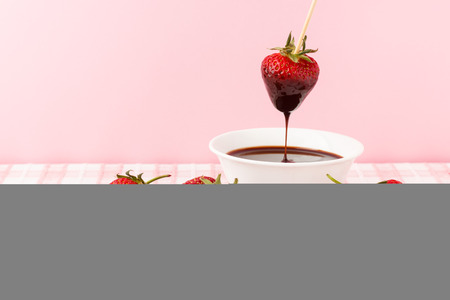 Strawberries and chocolate topping in white plateの写真素材