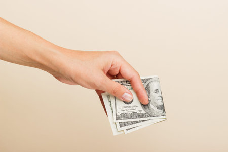 female hand holding dollars bills