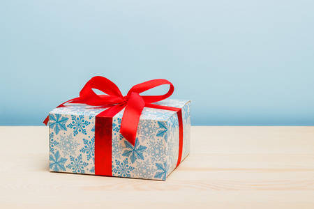 Cristmas gifts with red ribbons on the blue backgroundの写真素材