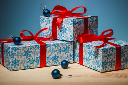 Cristmas gifts with red ribbons and blue ballsの写真素材