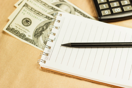 Image of money and a calculator, home budgetの写真素材